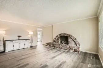 The living room showcases a custom wood-burning fireplace with a hearth.