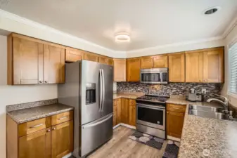 Beautiful countertops and full height backsplash complement this kitchen.