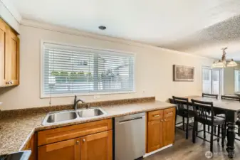 A window in the kitchen lets in more added light.