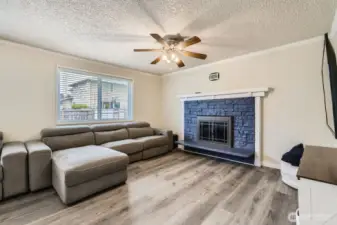 The family room with a cozy fireplace invites relaxation.
