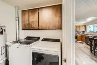 Laundry room with built-in cabinetry for extra storage.