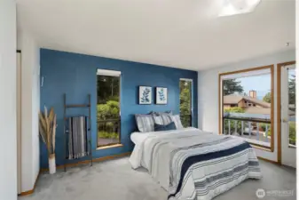 Primary bedroom with deck for morning coffee or leisurely reading.