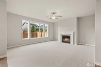 Family room is pre-wired for easy installation of TV and entertainment equipment and features a cozy gas fireplace with tile surround for those cooler evenings. Standard ceiling fan provides light and comfort. Oversized windows allowing lots of natural light into the open family room featuring 9' ceiling.