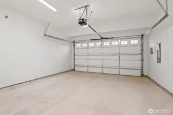 Double car garage is drywalled and includes standard garage door opener.
