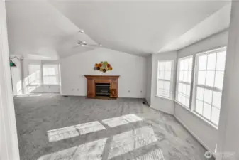 vaulted ceilings always add height to rooms, gas fireplace, bay windows add elegance