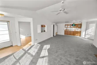 this angle shows the front screen door, the den entrance and the dining area