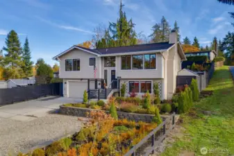 Front view of home, driveway and garden spaces