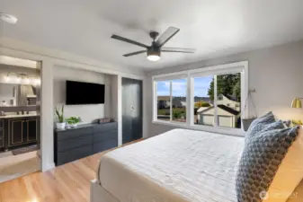 Primary bedroom with TV nook, closet to the right and Primary bath to the left