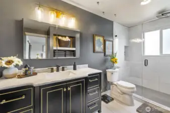 Primary bath remodel with newer vanity, lighting, flooring and shower with full height tile