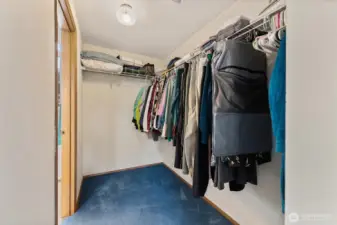 Spacious walk-in closet with built-in shelving and generous hanging space — ideal for maximizing storage and organization in the primary bedroom.