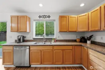 Large kitchen window looks out to the fully fenced back yard.
