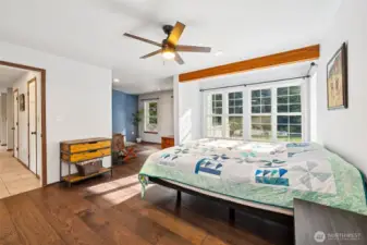Primary bedroom on the main floor complete with new engineered hardwood floors.