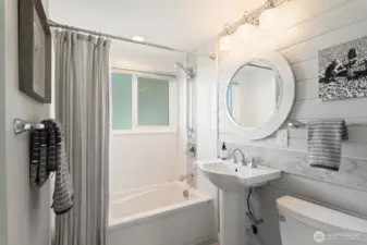 Kohler fixtures and a sunny full bath with tons of built in storage.