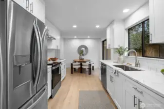 Cooking is a delight in this brand-new kitchen, featuring stunning quartz counters, soft-close drawers, updated fixtures, modern appliances, and stylish lighting.