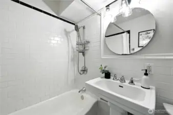Pretty white tile bath with charming pedestal sink!