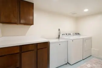 Large laundry with cabinet space.