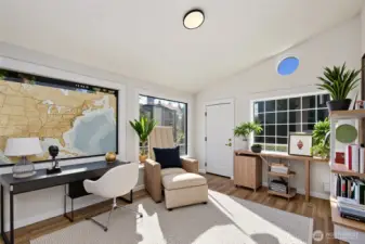 Beautiful sun room, shown here with virtual staging, is accessed through a sliding glass door in the hallway or from the front porch, and as a separate room could be used as a sunny third bedroom!