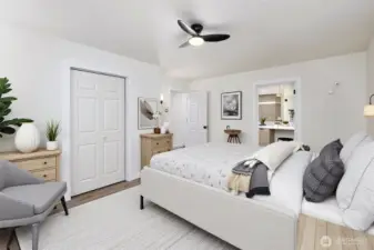 Large primary bedroom with ceiling fan for extra comfort, connects to the primary bath. Virtually staged.
