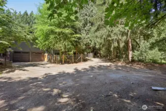 This is the west view after you walk down the stairs showing the fenced area, attached to the house and goes around the shop area....for pets?