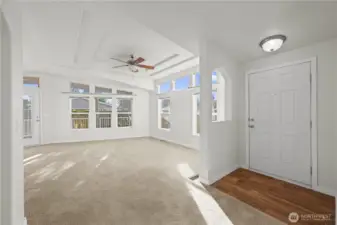 Sunlight fills every corner, highlighting the detailed ceiling and ceiling fan, creating a warm and welcoming atmosphere from the moment you step inside.