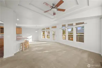 The open-concept great room seamlessly combines living and dining areas, with abundant natural light streaming through large windows—each thoughtfully equipped with window blinds for comfort and privacy.