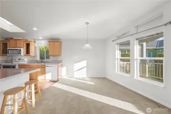 Convenient breakfast bar with seating, seamlessly flowing into the dining area—perfect for everyday living and entertaining.