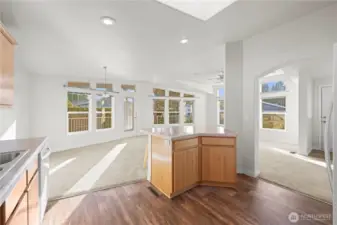 Hardwood-style flooring adds a touch of elegance, while the open layout flows seamlessly into the dining and living areas.