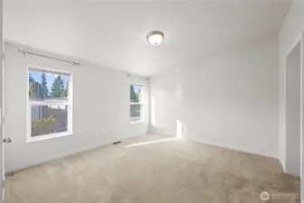 Step into the spacious primary bedroom filled with natural light, offering a peaceful retreat with room to relax and unwind.