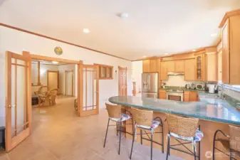 Generously sized kitchen with ample counter space and storage and an eat-in bar