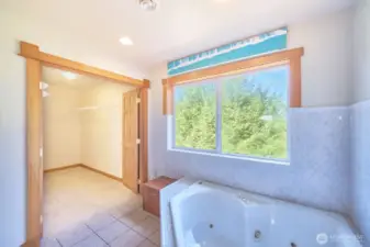 Well-appointed primary bathroom with soaking tub