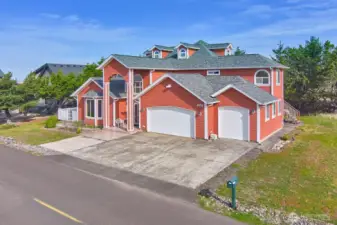 Concrete driveway and spacious three-car garage.