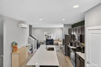 Bright and airy hallway leading to bedrooms, with recessed lighting and clean modern design