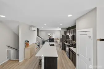 Sleek modern kitchen with white cabinetry and open flow to dining and living spaces
