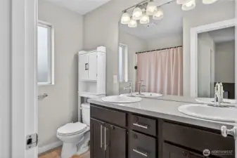 Master suite full bathroom featuring double sink vanity, soaking tub, and luxurious contemporary finishes