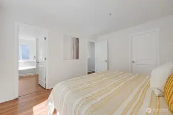 Spacious primary suite offers a serene retreat with a bright, airy layout and a seamless connection to its private ensuite. The adjoining primary bathroom features a relaxing soaking tub, a generous walk-in closet, and a clean, modern design that enhances everyday comfort. It’s a thoughtfully designed space that blends function and tranquility for a true retreat-style experience.