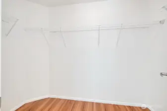 Primary suite includes a spacious walk-in closet with ample shelving and open storage, offering a clean and organized layout for effortless wardrobe management. Bright, well-lit, and thoughtfully designed, this closet provides generous room for clothing, accessories, and everyday essentials—an ideal extension of the primary retreat.