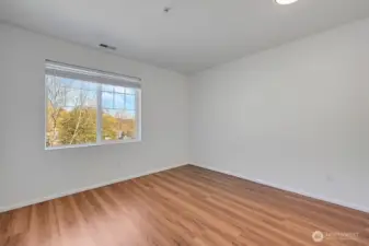 Bright bedroom features fresh interior paint, warm natural light, and a clean, modern feel. A large window frames beautiful mountain views, creating a serene backdrop for the space. With its simple layout and updated finishes, this room offers a peaceful retreat on the upper level.