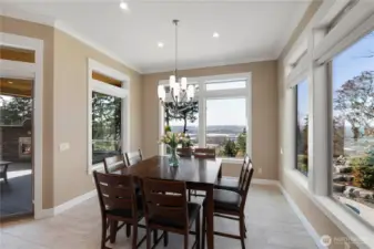 Dining with a view and easy access to outdoor living on the spacious deck featuring fireplace and western views