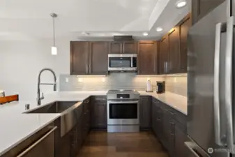 Cooking is easy in this kitchen with stainless steel appliances and large peninsula