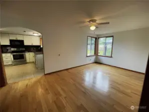 View from family room through your dining room with beautiful hardwood floor into the kitchen