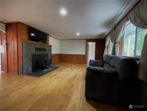 Stepping in the front door looking into your living room with beautiful hardwood floors fresh paint and wood stove, your primary bedroom and bath to the right on the opposite side of the house from the 2nd and 3rd bedrooms.