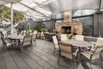 Covered terrace with gas grills, table seating and outdoor gas fireplace.