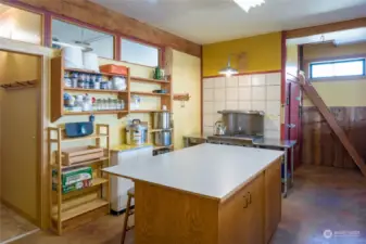 Part of the food prep kitchen in the Barn with walk in cooler in the red door.