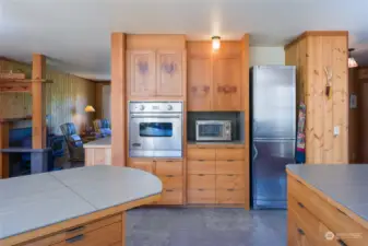 Other end of the kitchen with living room on the left.