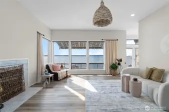 Tall windows with vaulted ceilings on living room looking to water views with elecrtic awning