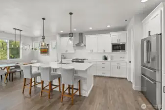 This chef’s kitchen is the heart of the home—featuring crisp white cabinetry, sleek stainless steel appliances, and a spacious island perfect for meal prep or casual gatherings.