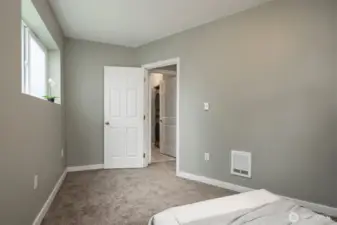 Main floor bedroom adjacent to full bathroom and living space.