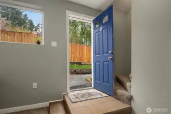 Front door opening to fully fenced yard.