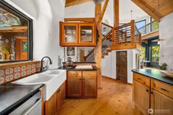 Check out those beautiful cabinets, and you get a glimpse of the stairwell to the master loft.