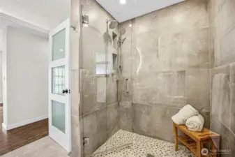 Main floor guest bathroom XL shower with custom tile work AND 'smart features' so that you can program the temperature and other settings you prefer.